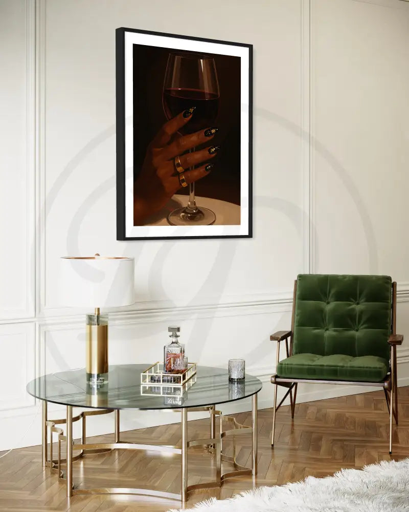 Black woman's hand holding wine glass with gold rings and nail art
