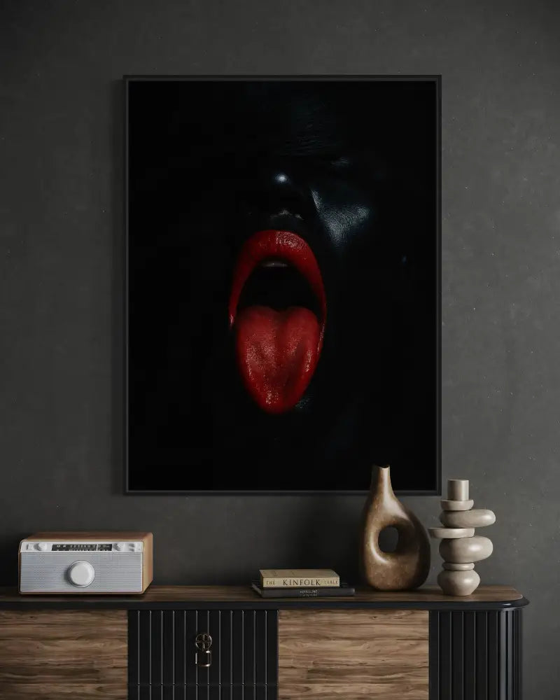 Afrocentric digital wall art of bold red lips and extended red tongue against black background.