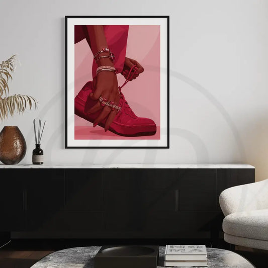 Afrocentric sneaker wall art of Black woman tying red sneakers